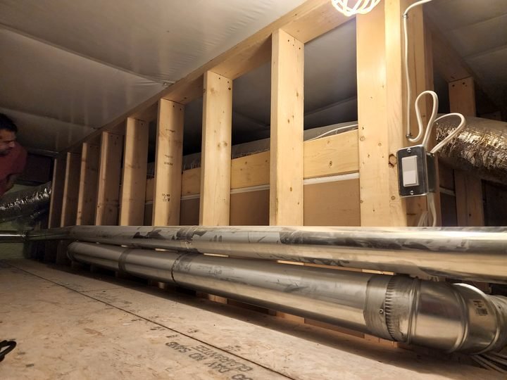 Mechanical piping installed along an interior wall